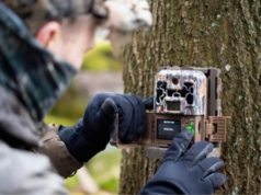man setting up trail camera