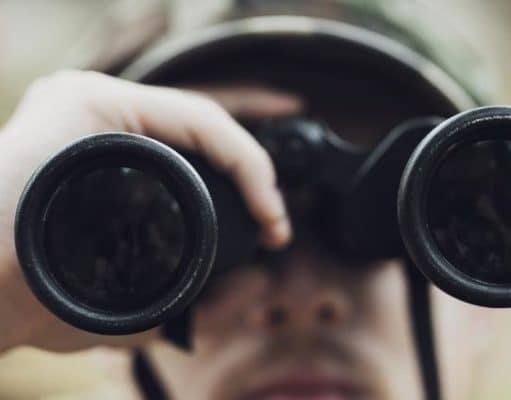 hunter looking into binoculars