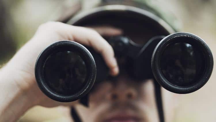 hunter looking into binoculars