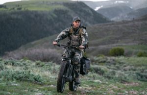 hunter riding ebike on the mountains
