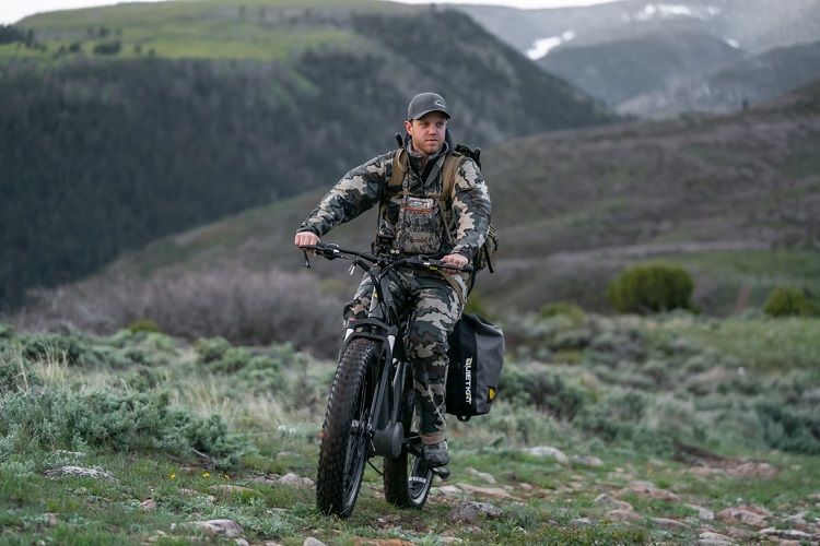 hunter riding ebike on the mountains