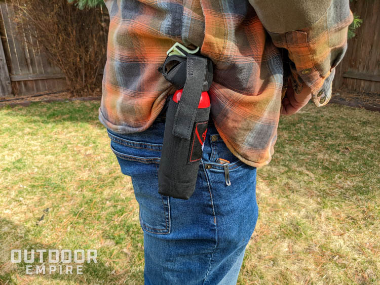Bear deterrent can in a holster on man's hip