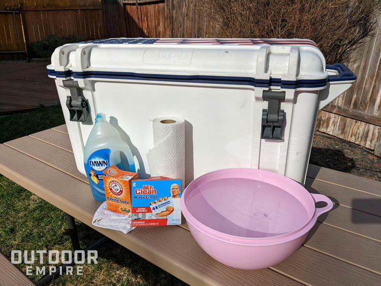 Cooler on a table with cleaning supplies in front
