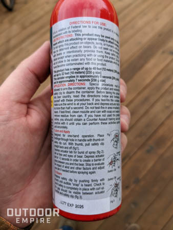 Bear deterrent label on canister showing expiration date