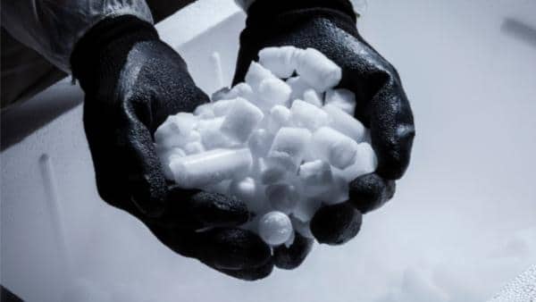 Gloved hand holding a bunch of dry ice