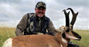 hunter with pronghorn with black patch on cheek
