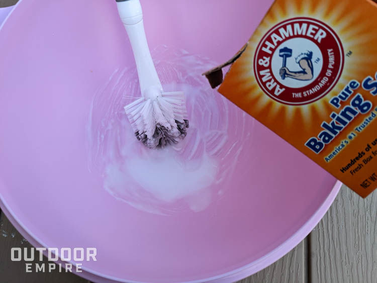 Pouring baking soda into a bowl to make a paste