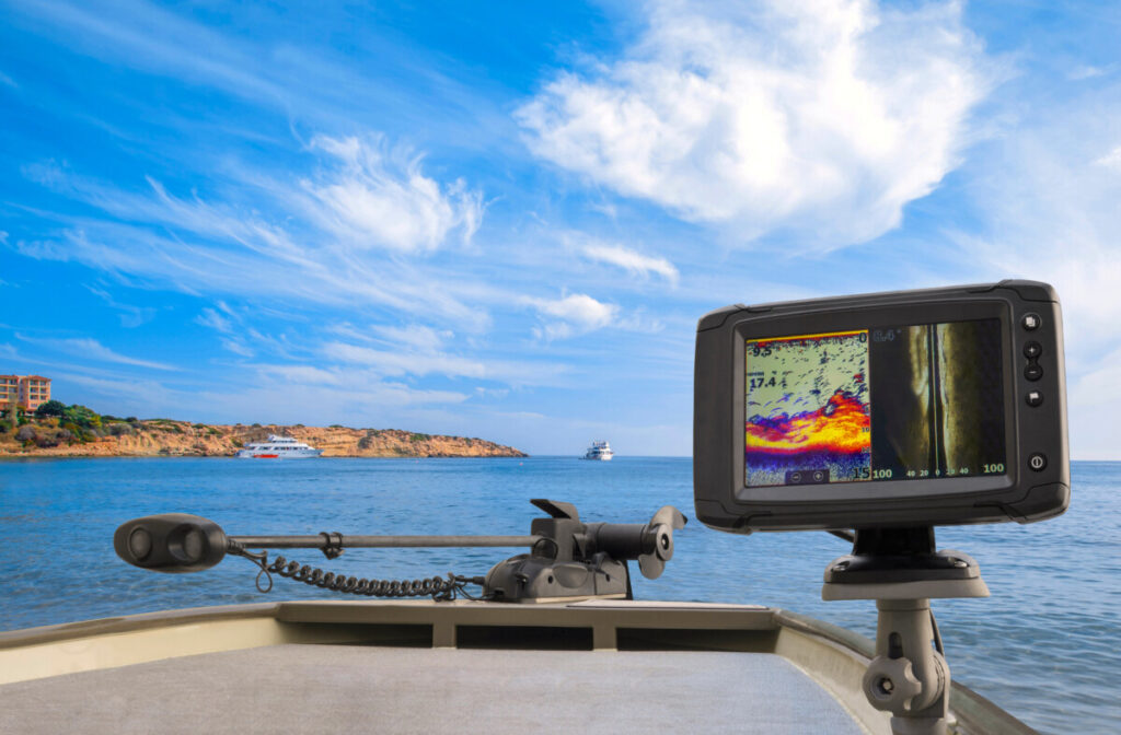 fishfinder on boat against a blue sky and water