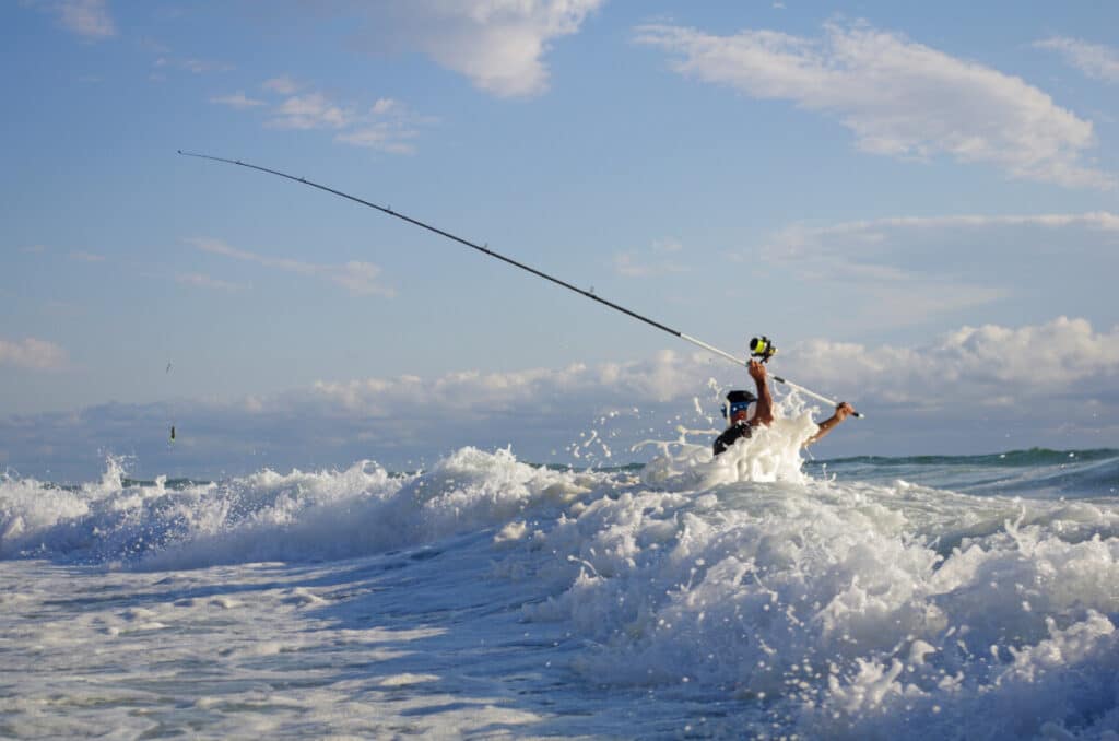 Angler surf fishing