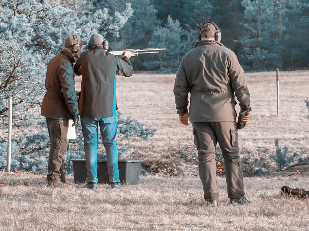 men shooting guns at a firing range