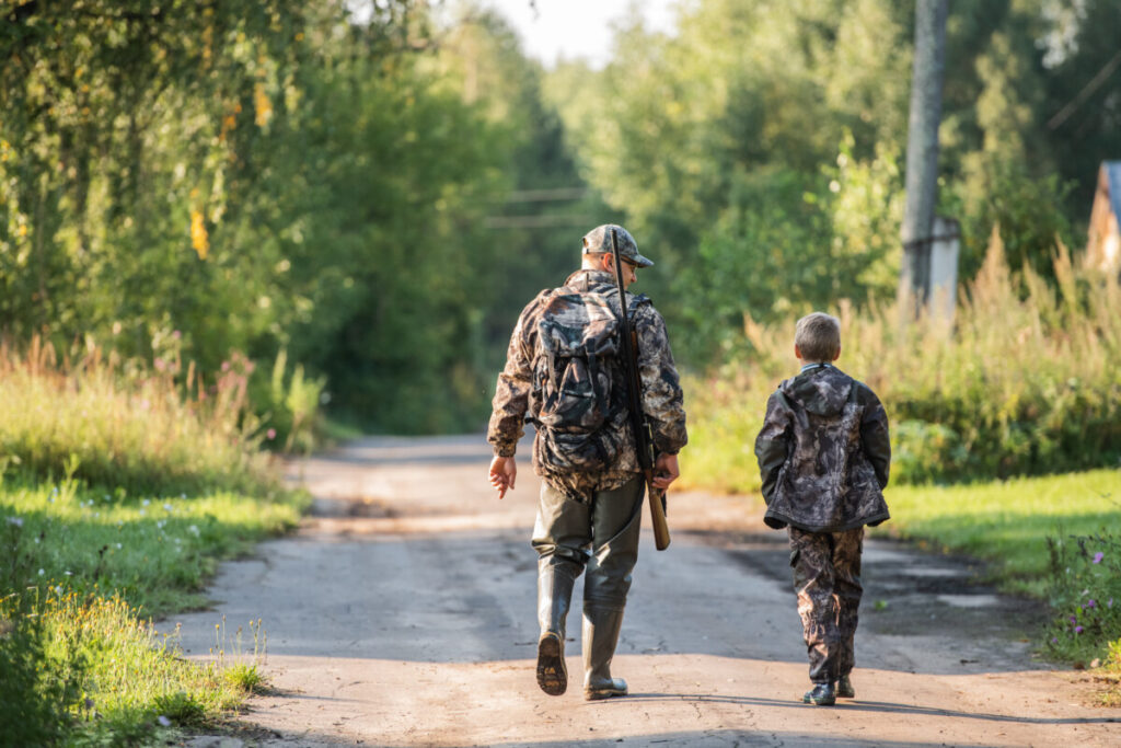 Father and son hunting in the woods