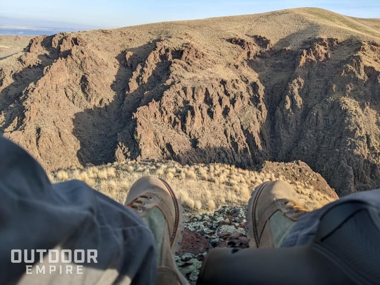 Looking out over a desert canyon with feet in foreground
