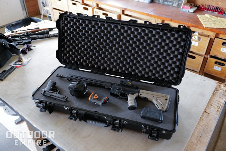 Nanuk 985 AR15 case open with rifle, pistol, and accessories