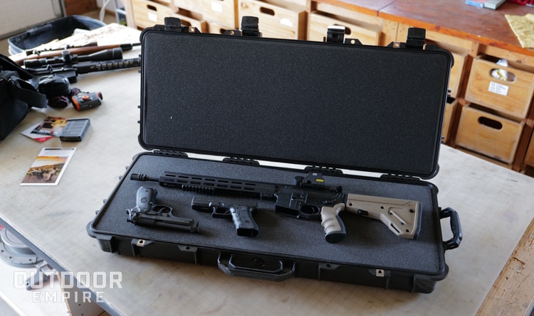 Pelican Protector 1700 case open with AR15 and two pistols