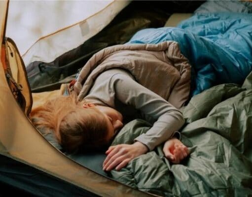 woman sleeping in tent