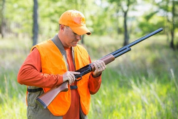 bird hunter holding Pump Action shotgun