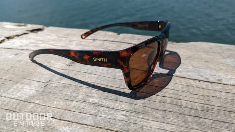 Side of Smith Joya sunglasses on bench