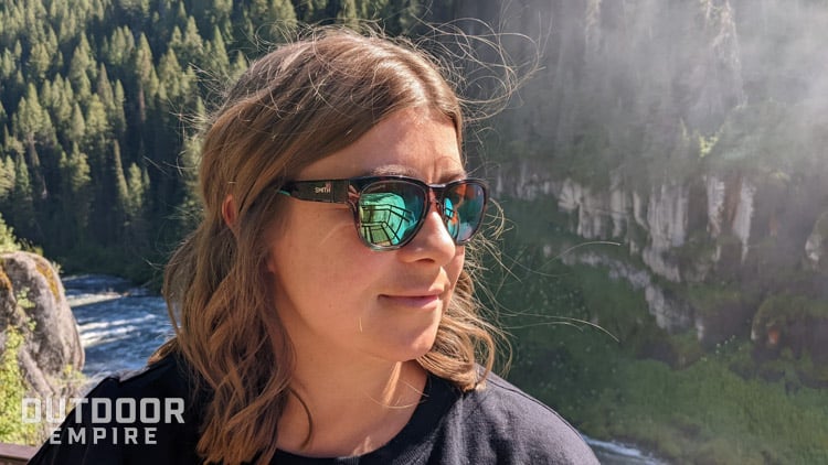 Woman wearing smith rockaway sunglasses with waterfall reflecting in lenses