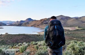 hiker carrying Gregory Focal overlooking reservoir