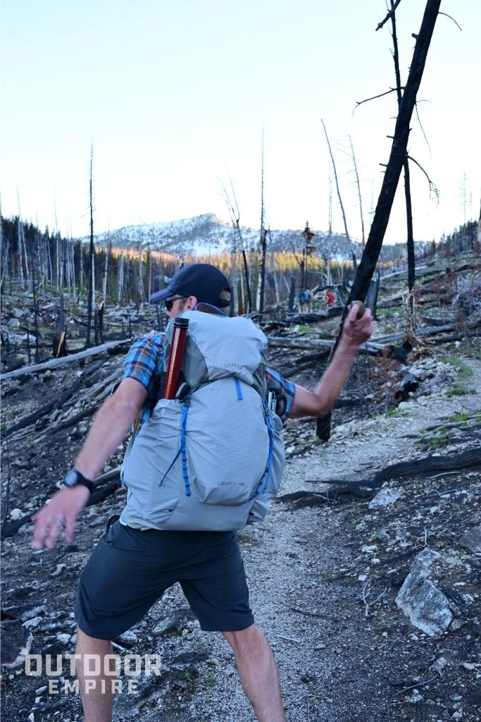 hiker with Osprey Levity 45 throwing rock