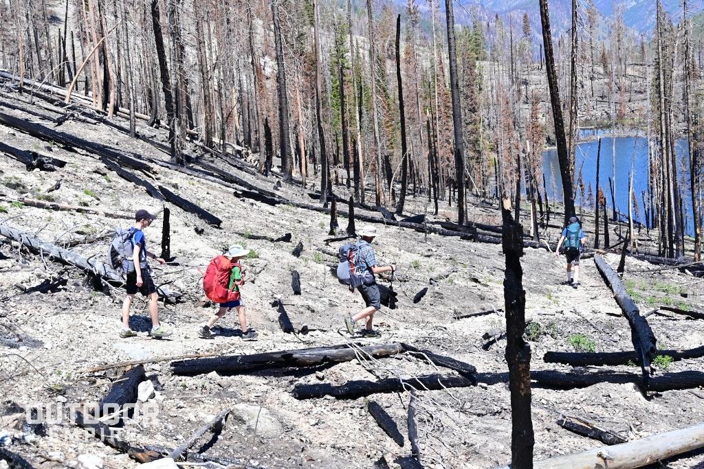 Hikers on burned trail