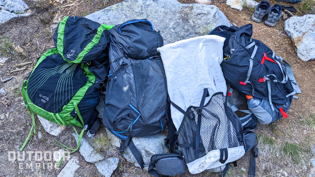 Four ultralight backpacks on a rock