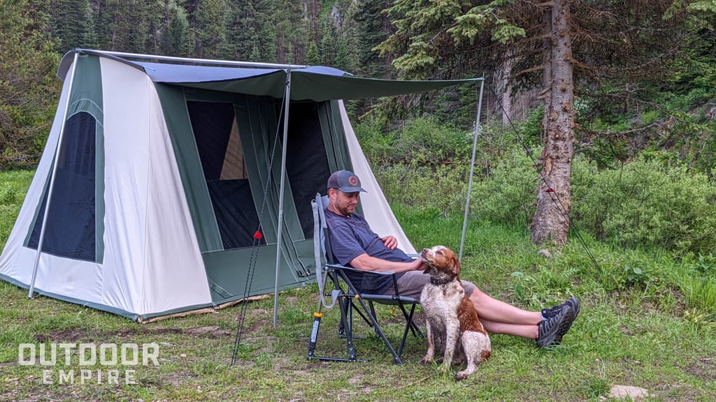 Man with dog in front of white duck prota tent