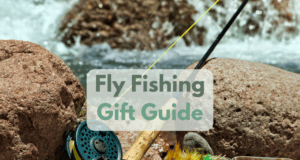 Fly fishing gear on rock by river