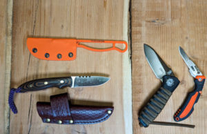Different types of hunting knives on a table