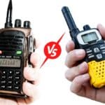 Handheld ham radio in one hand and a walkie talkie in another hand with a vs symbol in between