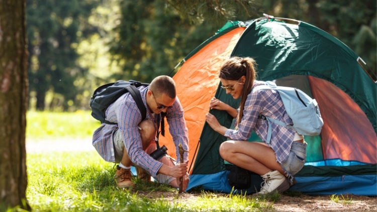 Couple pitching tent