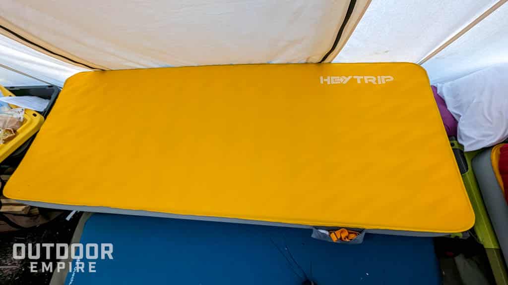 Self inflating foam sleeping pad on a cot in a tent in cold weather