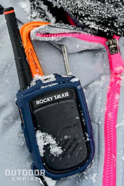 Rocky Talkie clipped to a snowy coat.