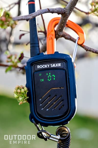 Front display of a Rocky Talkie hooked to a tree branch.