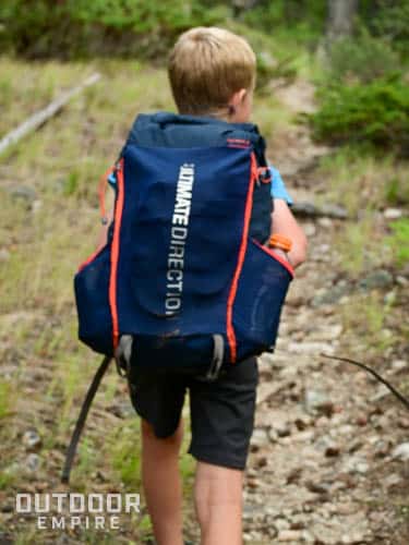 Boy with ultralight backpack on a trail.