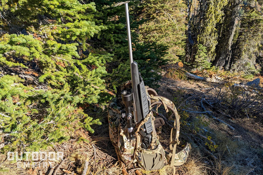 Sitka gear mountain 2700 pack sitting on ground with rifle in side pocket