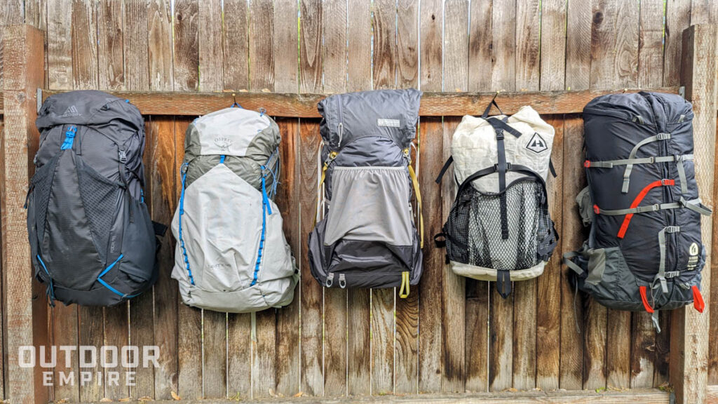 Five ultralight backpacks of 2023 for hiking hanging on a fence