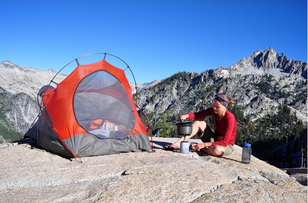 Hiker by her backpacking tent