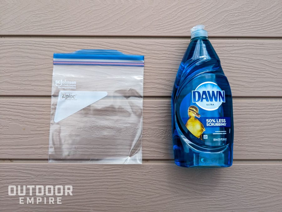 Ziploc bag next to a bottle of Dawn dish soap for making a DIY ice pack