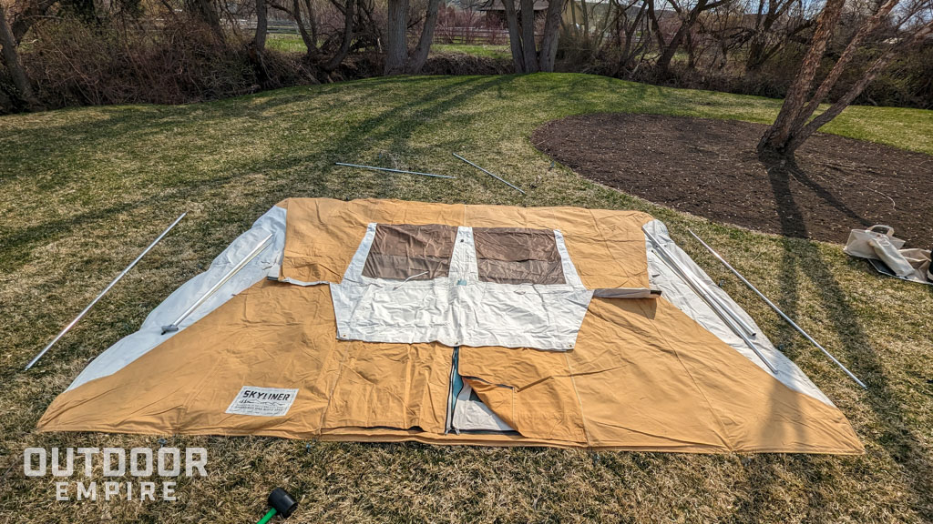 Springbar skyliner tent laid out on ground and staked to ground