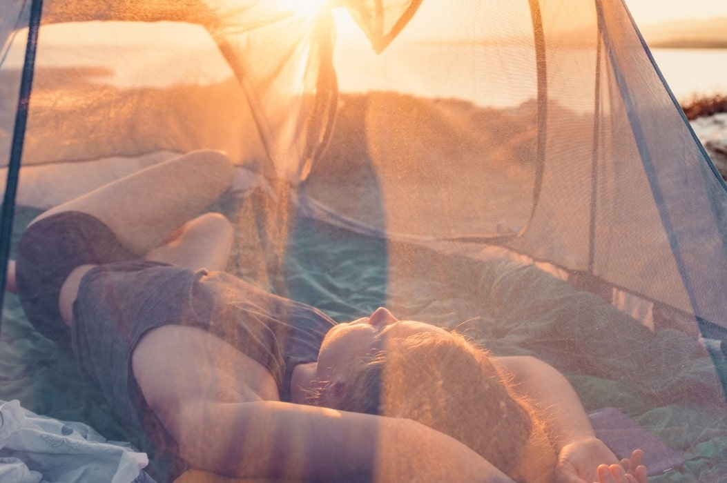 Woman sleeping alone in tent