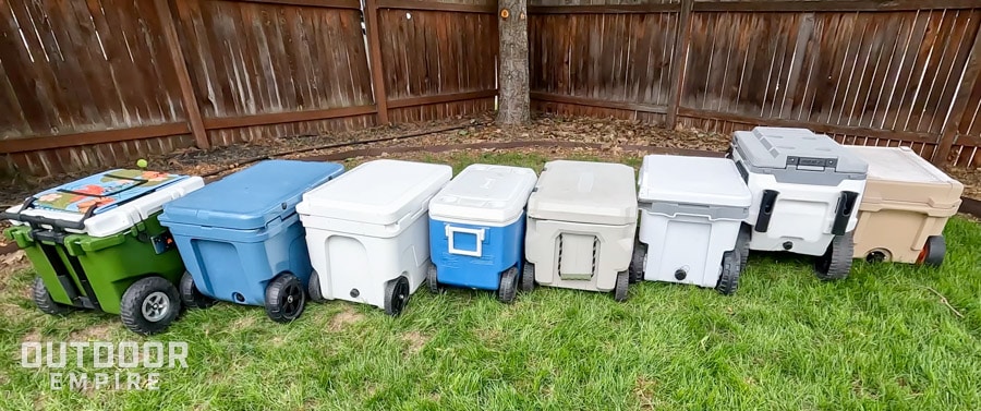 Row of wheeled coolers staggered next to each other on a lawn