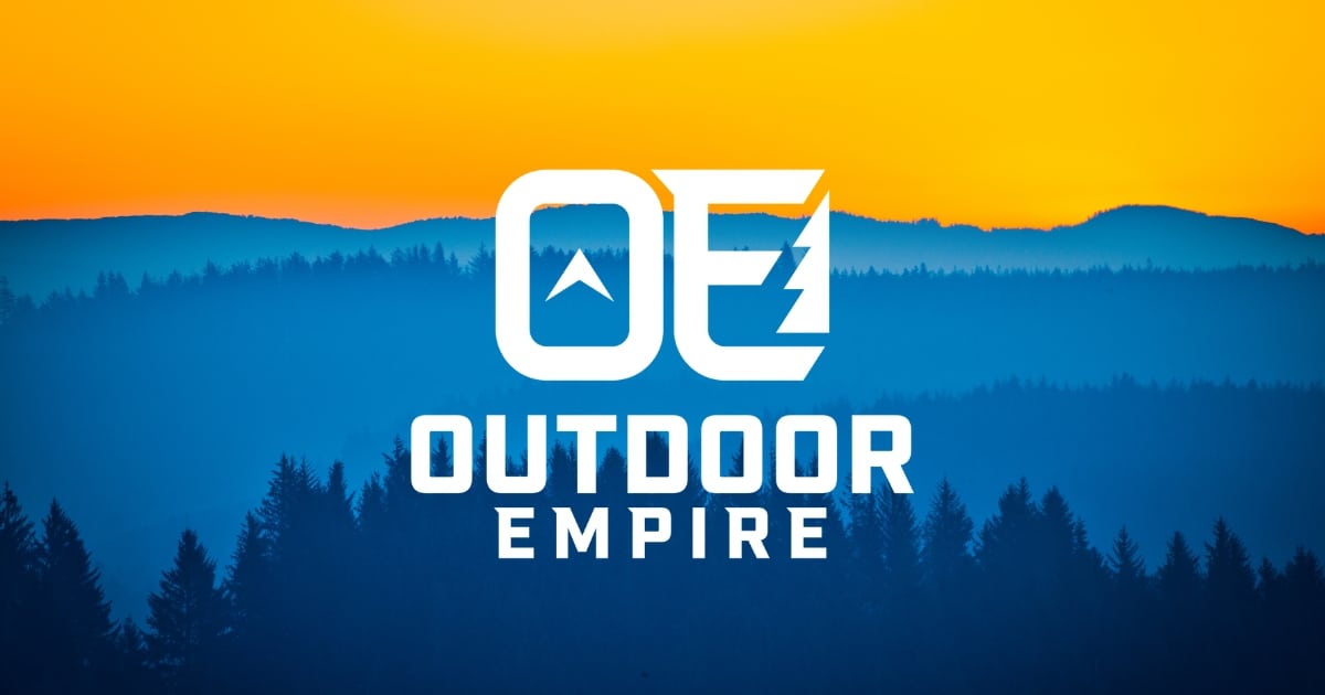 Outdoor empire logo with mountains at sunset in background