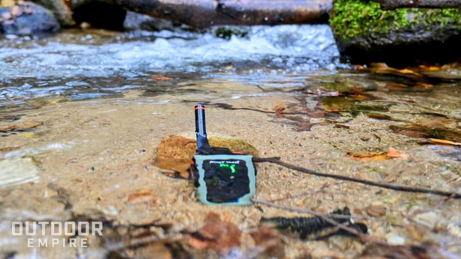 Rocky talkie 5 watt radio submerged in water in a mountain stream