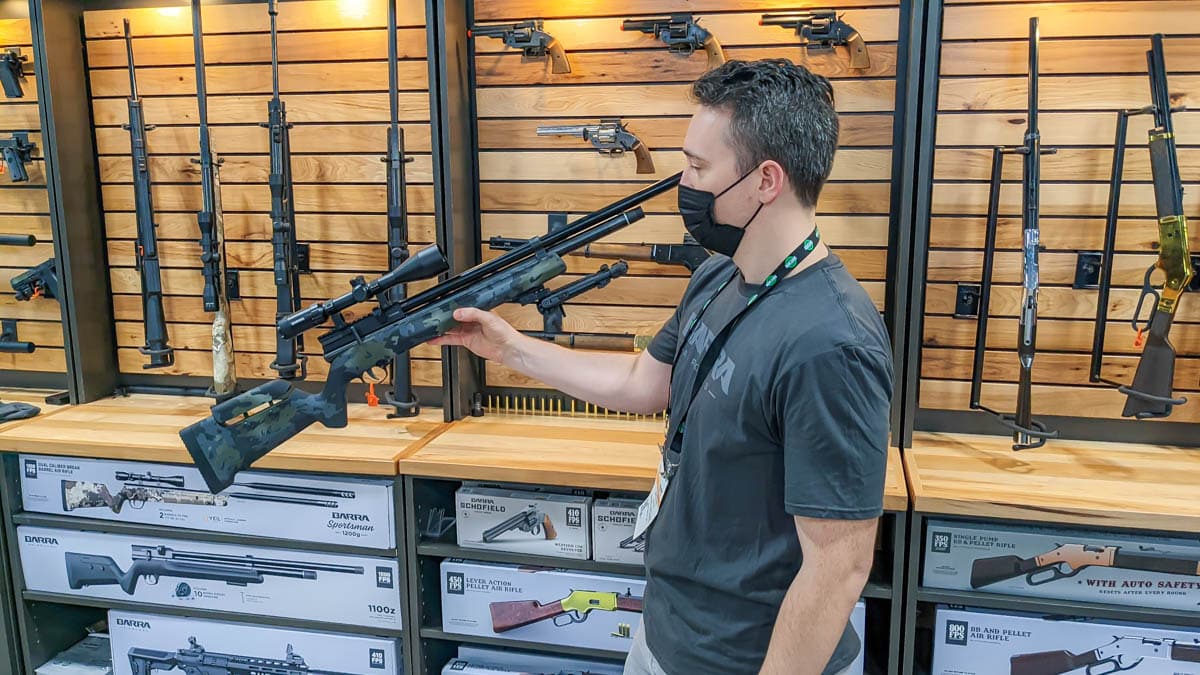 Man holding airgun in a tradeshow booth