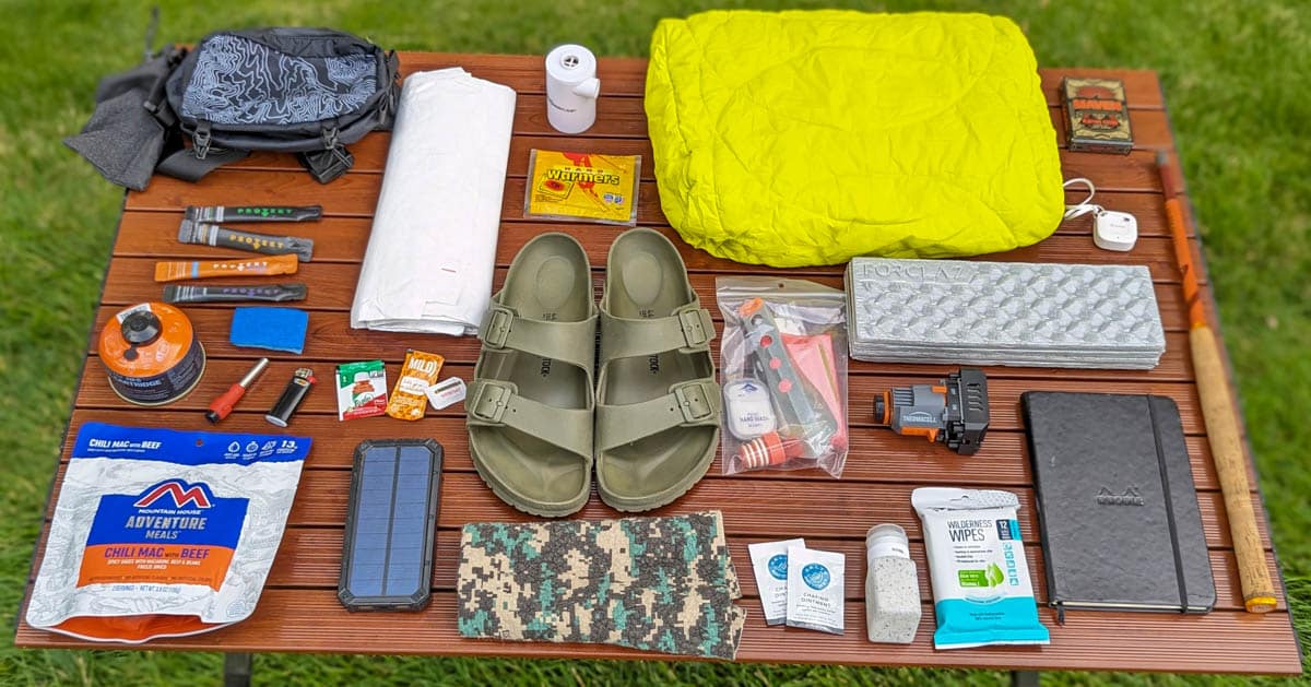 Table with several outdoor gear items on it
